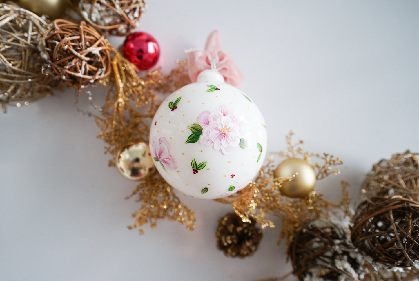 Hand painted florals and mistletoe on white glass ornament