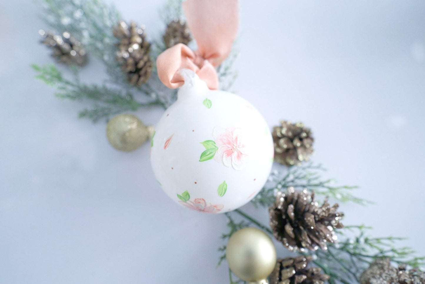 Hand painted peach and white florals on white glass ornament