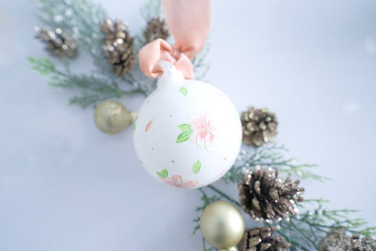 Hand painted peach and white florals on white glass ornament