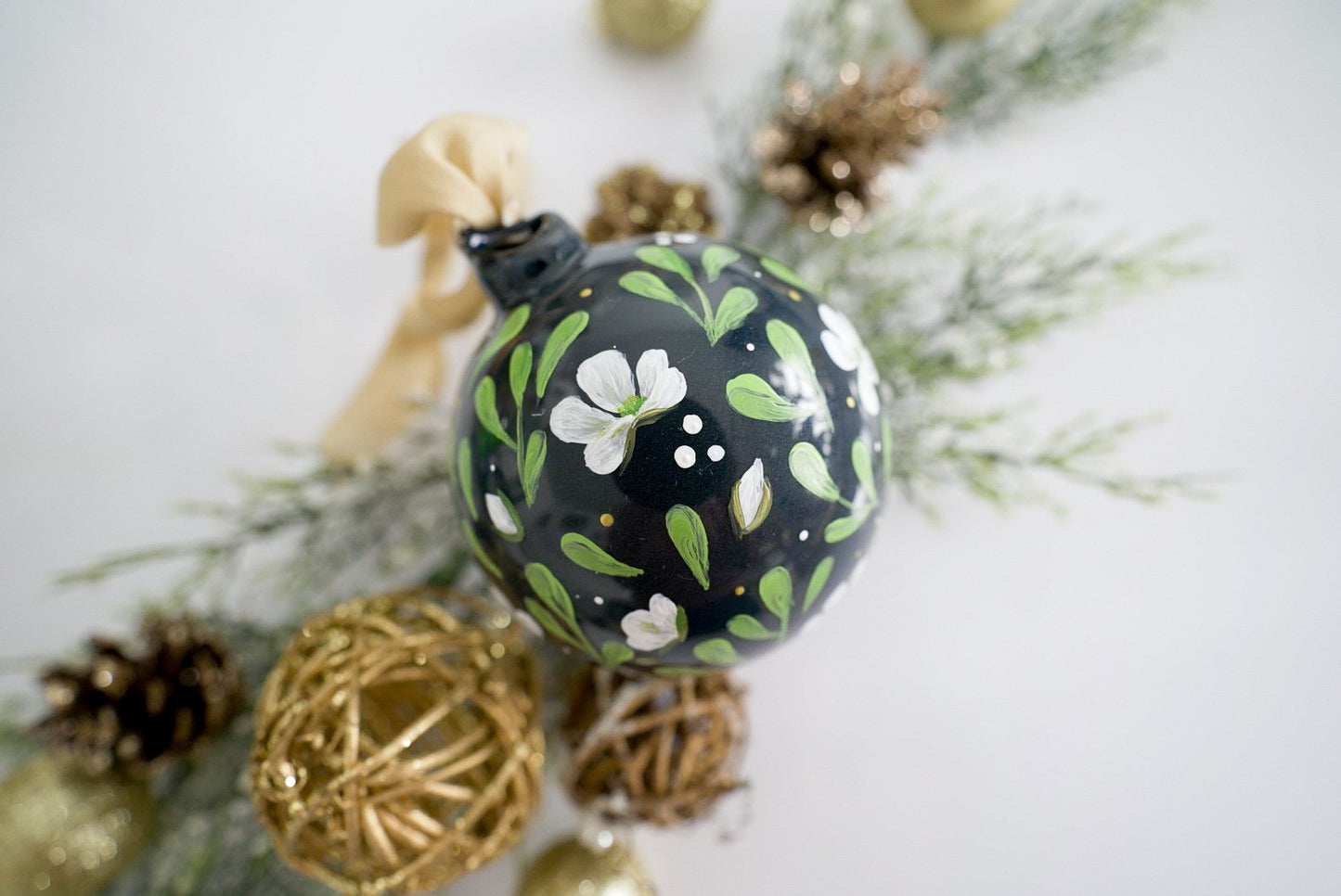 Hand painted white magnolias on black glass ornament
