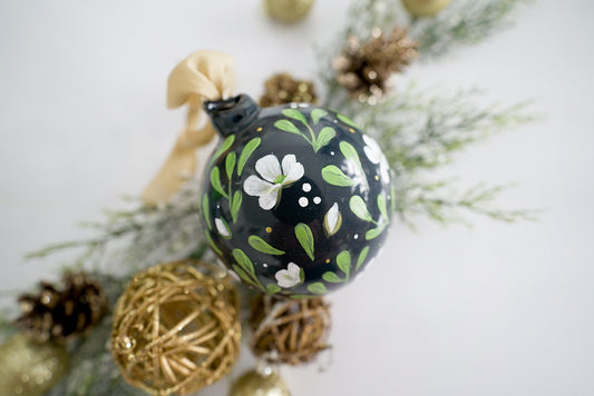 Hand painted white magnolias on black glass ornament