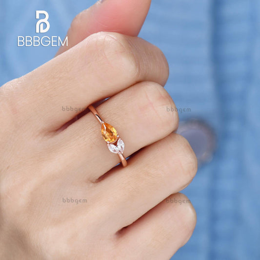 Horizontal East-West Pear Shaped Spessartite Garnet Ring with Accents Moissanite Basket Setting