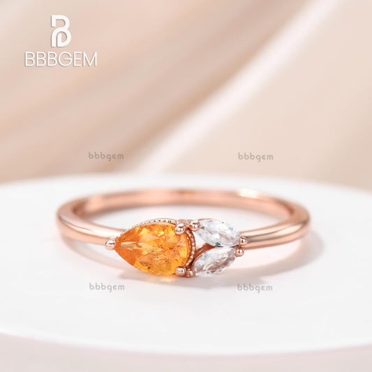 Horizontal East-West Pear Shaped Spessartite Garnet Ring with Accents Moissanite Basket Setting